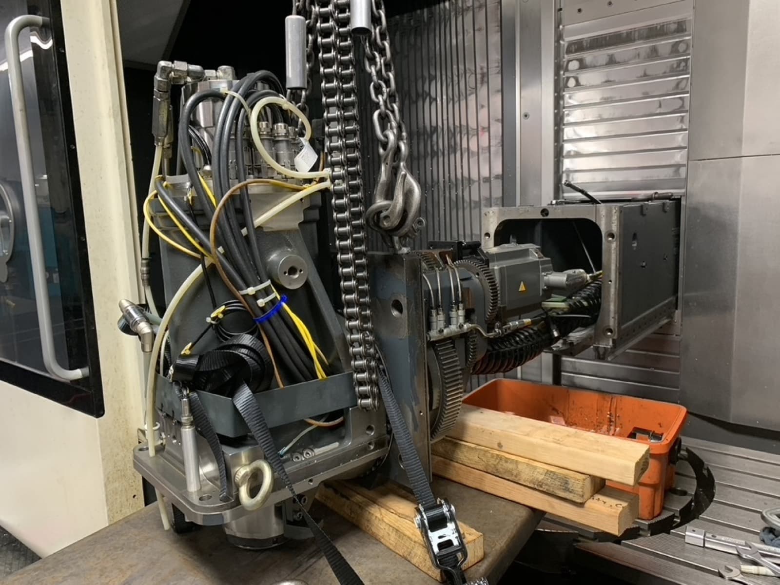 Milling head lifted out of the machine on a hoist