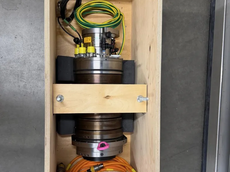 Spindle secured with a wooden cross-brace in its shipping crate
