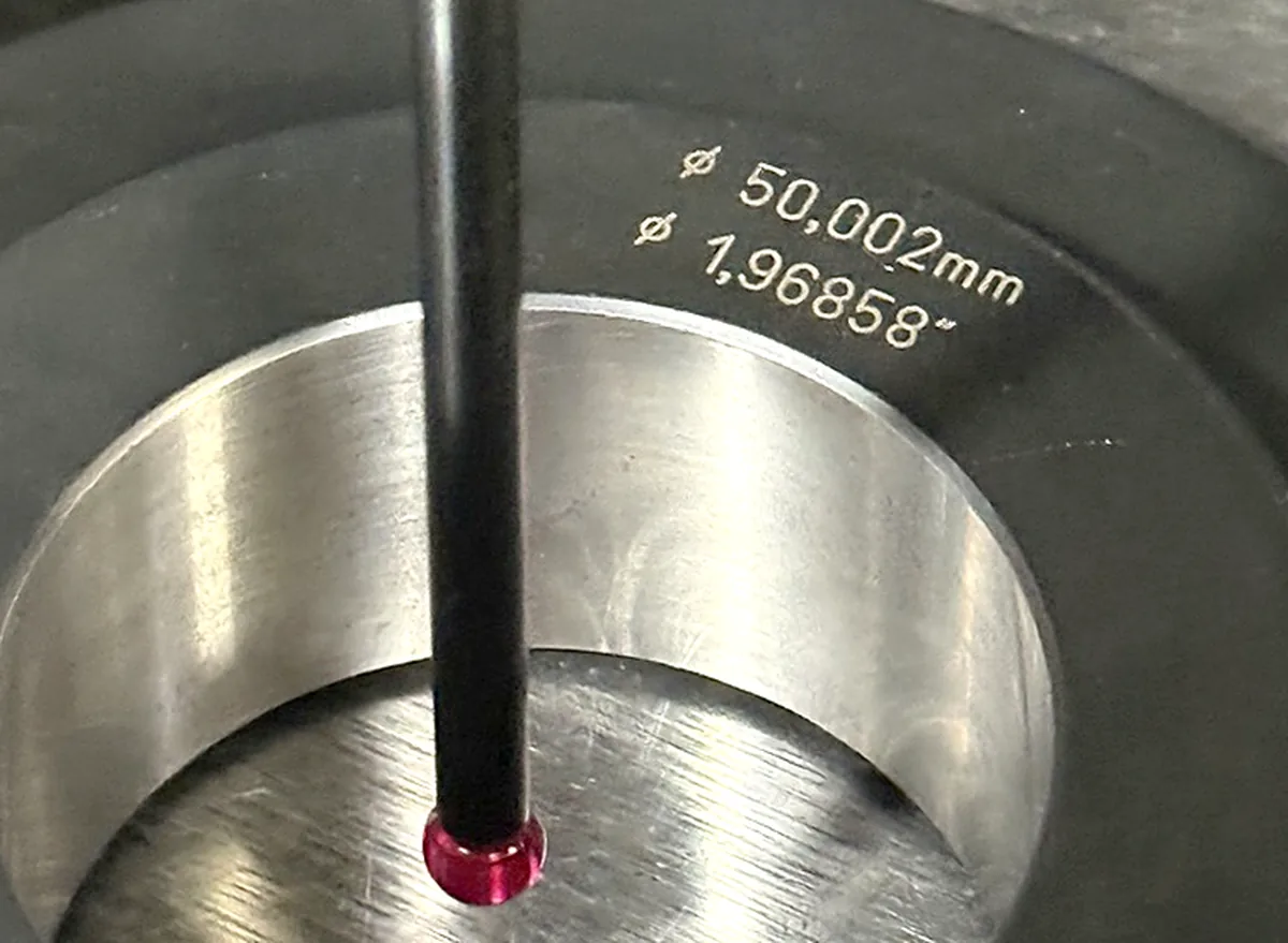 Touch-probe measuring a 50.002 mm master ring gauge during machine calibration