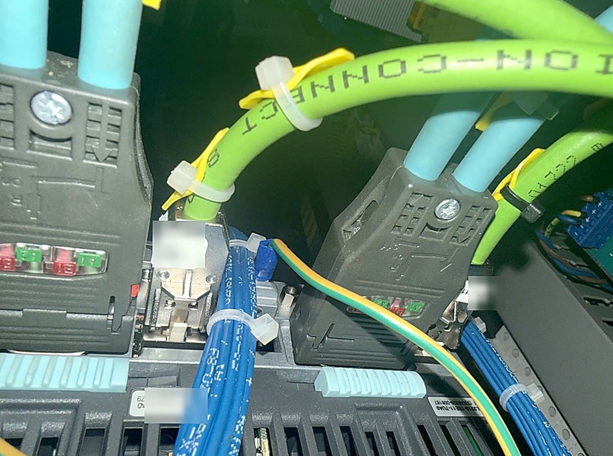Siemens drive connectors and control wiring inside a CNC machine cabinet during electrical repair